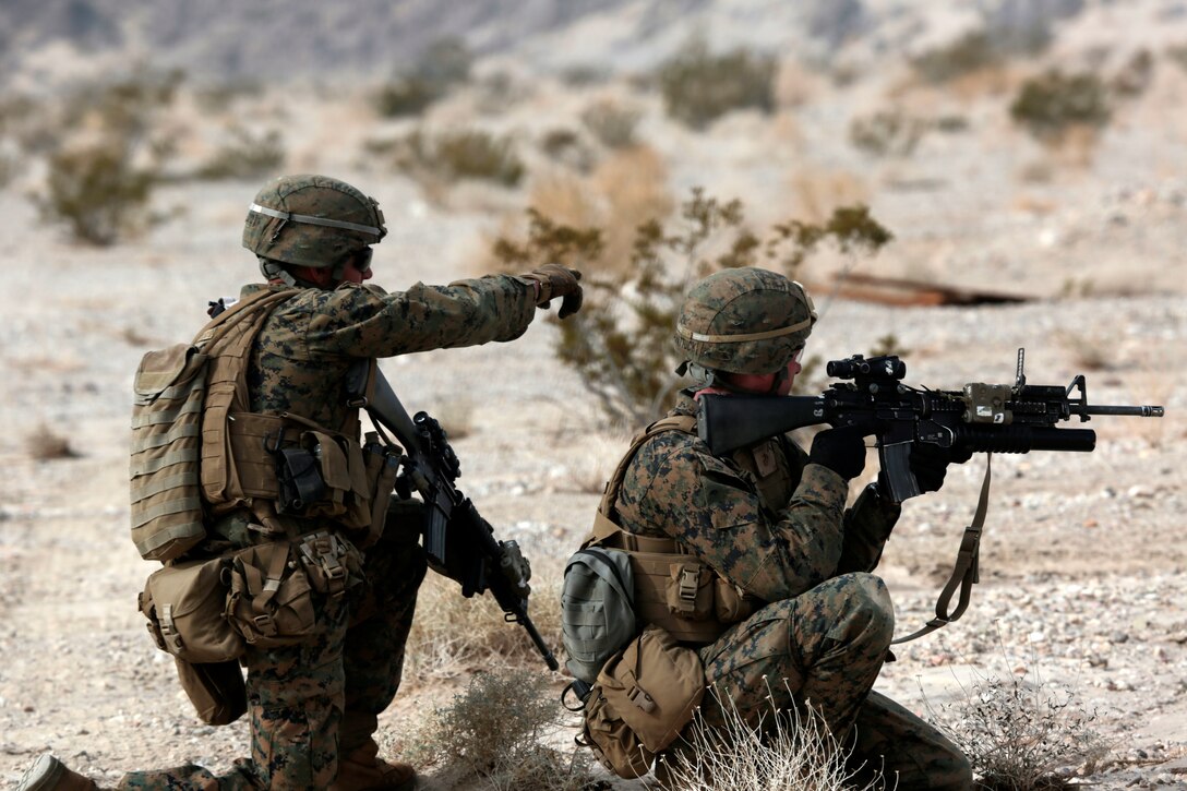 U.S. Marine Corps Lance Cpl. Nolan Floyd, left, instructs Pfc. Nathan ...