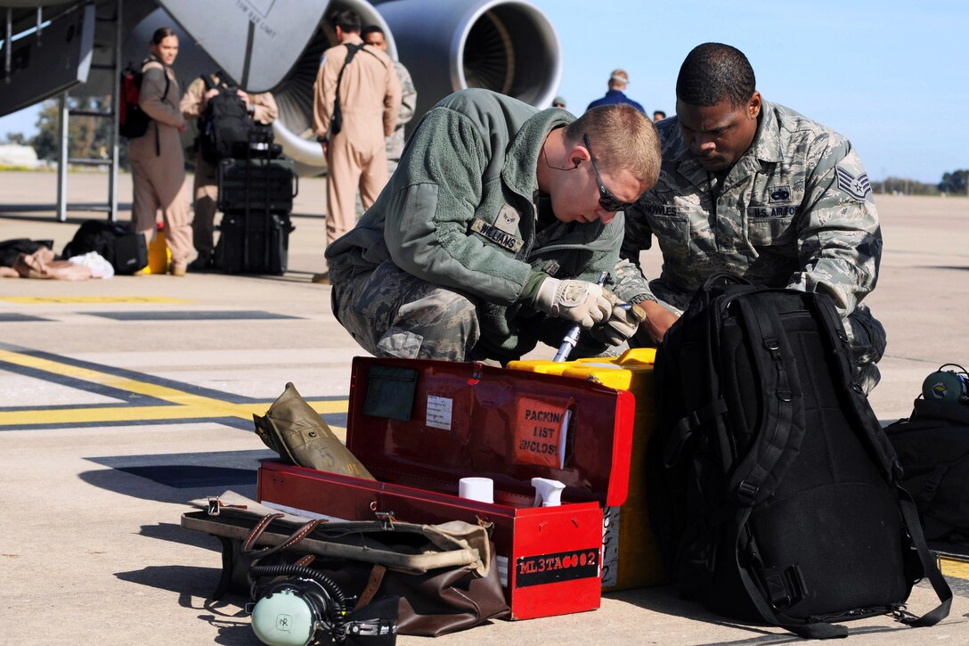 U.S. Air Force Airman 1st Class Colton Williams, left, and U.S. Air Force Staff Sgt. Michael Dedmon complete postflight recovery procedures on a KC-135 Stratotanker aircraft at an undisclosed location in southwest Europe after a mission over Africa, Feb. 3, 2013. Willaims and Dedmon, crew chiefs, are assigned to the 100th Aircraft Maintenance Squadron, England.
