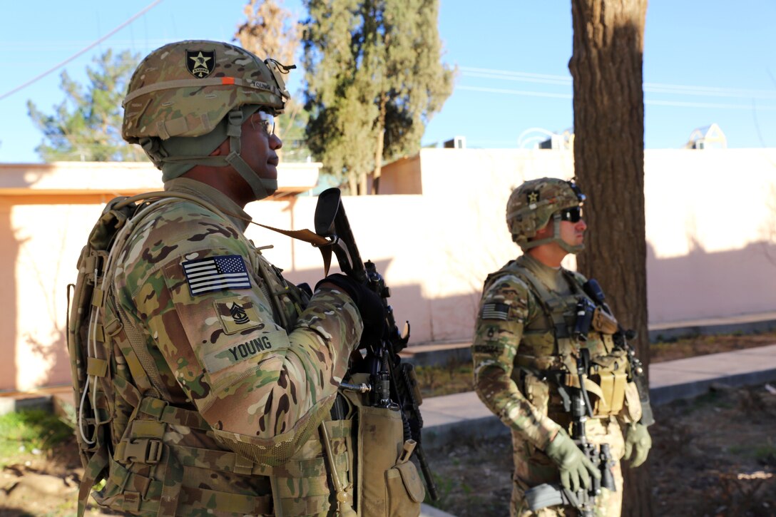 U.S. Army 1st Sgt. Raymond Young, left, and U.S. Army Sgt. 1st Class Sal Somoza provide security outside the Farah provincial governor's compound in Farah City, Afghanistan, Feb. 5, 2013. Young and Somoza are assigned to Provincial Reconstruction Team Farah.