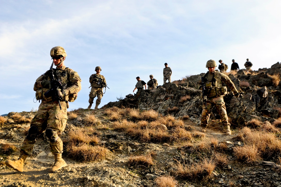 U.S. soldiers patrol down a mountain after visiting an Afghan border police observation point in Kunar province, Afghanistan, Jan. 28, 2013.