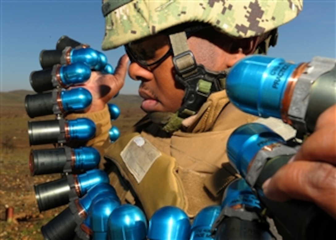U.S. Navy Constructionman William Reaws readies 40mm training grenades for firing from a Mk19 grenade launcher during a weapons qualifications and familiarization exercise held at Camp Roberts in Paso Robles, Calif., on Jan. 30, 2012.  Approximately 400 Seabees from Naval Mobile Construction Battalion 3 are receiving weapons training in preparation for a deployment scheduled later this year.   
