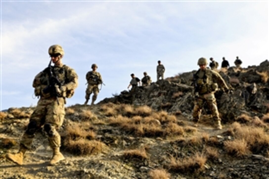 U.S. soldiers patrol down a mountain after visiting an Afghan border police observation point in Kunar province, Afghanistan, Jan. 28, 2013. 