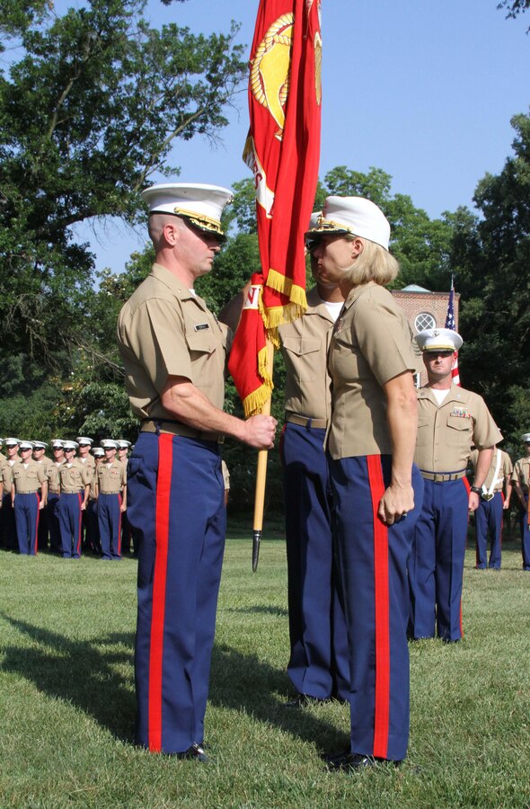 Maj. Brandon J. Gorman, left, received the Marine Corps Recruiting Station Raleigh colors from Jennifer A. Nash, right, during a change of command ceremony at North Carolina State University Raleigh, N.C. After 36 months with RS Raleigh, Maj. Nash passed the responsibilities of commanding officer onto Maj. Gorman.