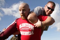 Clinton High School football coach Christopher Smoot carries a fellow educator from Recruiting Station Kansas City during the maneuver under fire portion of a modified combat fitness test Jan. 29. For additional imagery from the event, visit www.facebook.com/rstwincities.  
