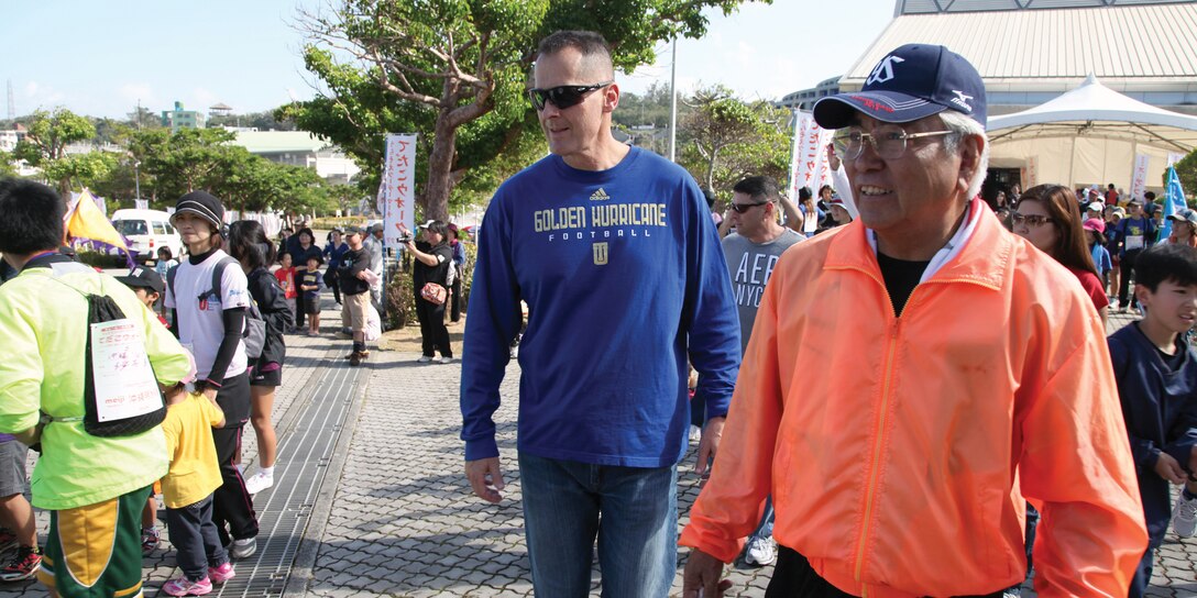 Mitsuo Gima and Col. John E. Kasperski participate the opening day of the annual Urasoe City tedako walk Feb. 2. The two-day event allowed participants to experience historic sites while promoting a healthy lifestyle. Gima is the mayor of Urasoe City, and Kasperski is the Camp Kinser commander and commanding officer of Combat Logistics Regiment 37, 3rd Marine Logistics Group, III Marine Expeditionary Force. 