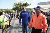 Mitsuo Gima and Col. John E. Kasperski participate the opening day of the annual Urasoe City tedako walk Feb. 2. The two-day event allowed participants to experience historic sites while promoting a healthy lifestyle. Gima is the mayor of Urasoe City, and Kasperski is the Camp Kinser commander and commanding officer of Combat Logistics Regiment 37, 3rd Marine Logistics Group, III Marine Expeditionary Force.