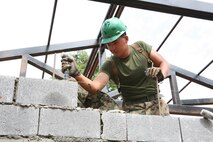 U.S. Marine Lance Cpl. Cuong V. Cao lays concrete cinder blocks into a wall Feb. 1 during the construction of a new building at Ban Kuad Nam Man School, Chat Trakarn District, Phitsanulok province, Kingdom of Thailand. Cao has become a valued friend to the students of Ban Kuad Nam Man School and takes advantage of every opportunity to learn and spend quality time with the children at the school. Similar structures are being built at four other schools during ongoing engineering civic assistance projects part of exercise Cobra Gold 2013. Cobra Gold, in its 32nd iteration, is a multinational exercise that promotes regional prosperity, security and cooperation among partner militaries. Cao is a combat engineer with 9th Engineer Support Battalion, 3rd Marine Logistics Group, III Marine Expeditionary Force.
 