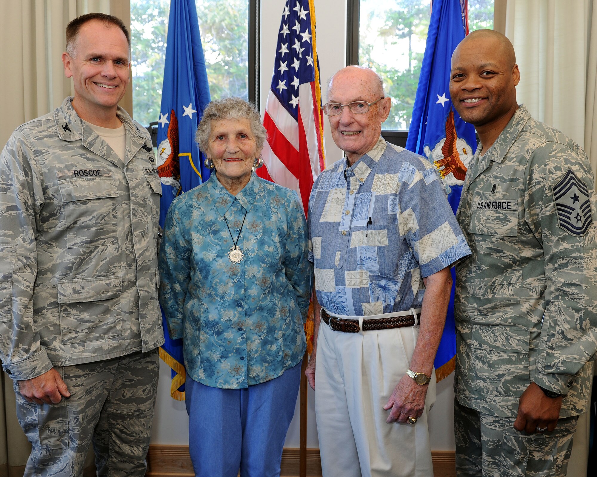 Col. John Roscoe, 15th Wing commander, joins Mrs. Kathy McCoy, her spouse retired Chief Master Sgt. of the Air Force James McCoy and Chief Master Sgt. Leslie Bramlett, 15th Wing command chief for a group photo at the 15th Wing headquarters building, Joint Base Pearl Harbor-Hickam, Hawaii, Feb. 7, 2013.  McCoy, while visiting family on-island, took the opportunity to check on the progress of the 15th Wing and their Airmen. McCoy served as the sixth chief master sergeant of the Air Force from 1979-1981.  (U.S. Air Force photo/Tech. Sgt. Jerome S. Tayborn)