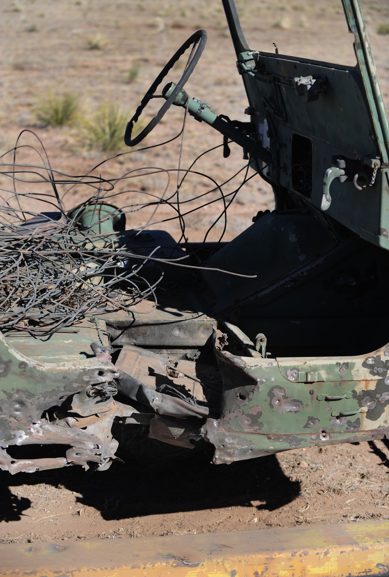 A target being towed by an unmanned vehicle is damaged by a 40mm shell at Melrose Air Force Range, N.M., Feb. 4, 2013. The unmanned vehicle is a new piece of equipment recently acquired by Cannon Air Force Base, N.M. Its remote-control capabilities allow the squadrons to practice shooting at a moving target without putting any human life in danger. (U.S. Air Force photo/Airman 1st Class Ericka Engblom)