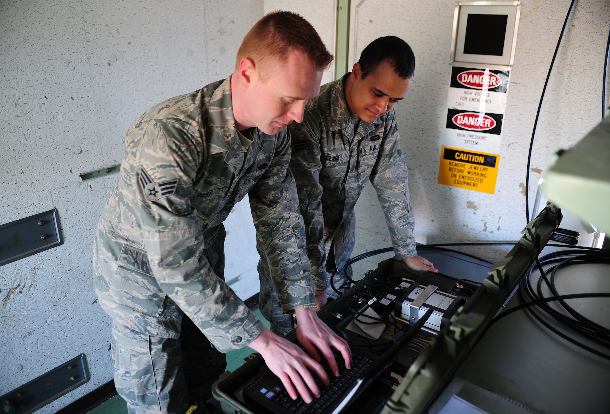 U.S. Air Force Senior Airmen Phillip Post and Senior Airman Antwan Clark, 27th Special Operations Air Operations Squadron, control an unmanned vehicle from a booth at Melrose Air Force Range, N.M., Feb. 4, 2013. The unmanned vehicle is a new piece of equipment recently acquired by Cannon Air Force Base, N.M. Its remote-control capabilities allow the squadrons to practice shooting at a moving target without putting any human life in danger. (U.S. Air Force photo/Airman 1st Class Ericka Engblom)