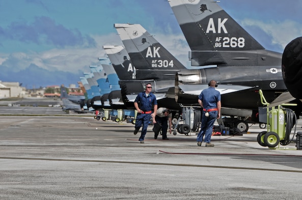 U.S. Air Force Airmen from the 18th Expeditionary Aircraft Maintenance Squadron, Kadena Air Base, Japan, conduct preflight checks on F-16 Fighting Falcons from the 354th Fighter Wing, Eielson Air Force Base, Ala., in support of exercise Cope North 2013 at Andersen Air Force Base, Guam, Feb. 7, 2013. Cope North is an annual air combat tactics, humanitarian assistance and disaster relief exercise designed to increase the readiness and interoperability of the U.S. Air Force, Japan Air Self-Defense Force and Royal Australian Air Force. (U.S. Air Force photo by Airman 1st Class Marianique Santos/RELEASED)