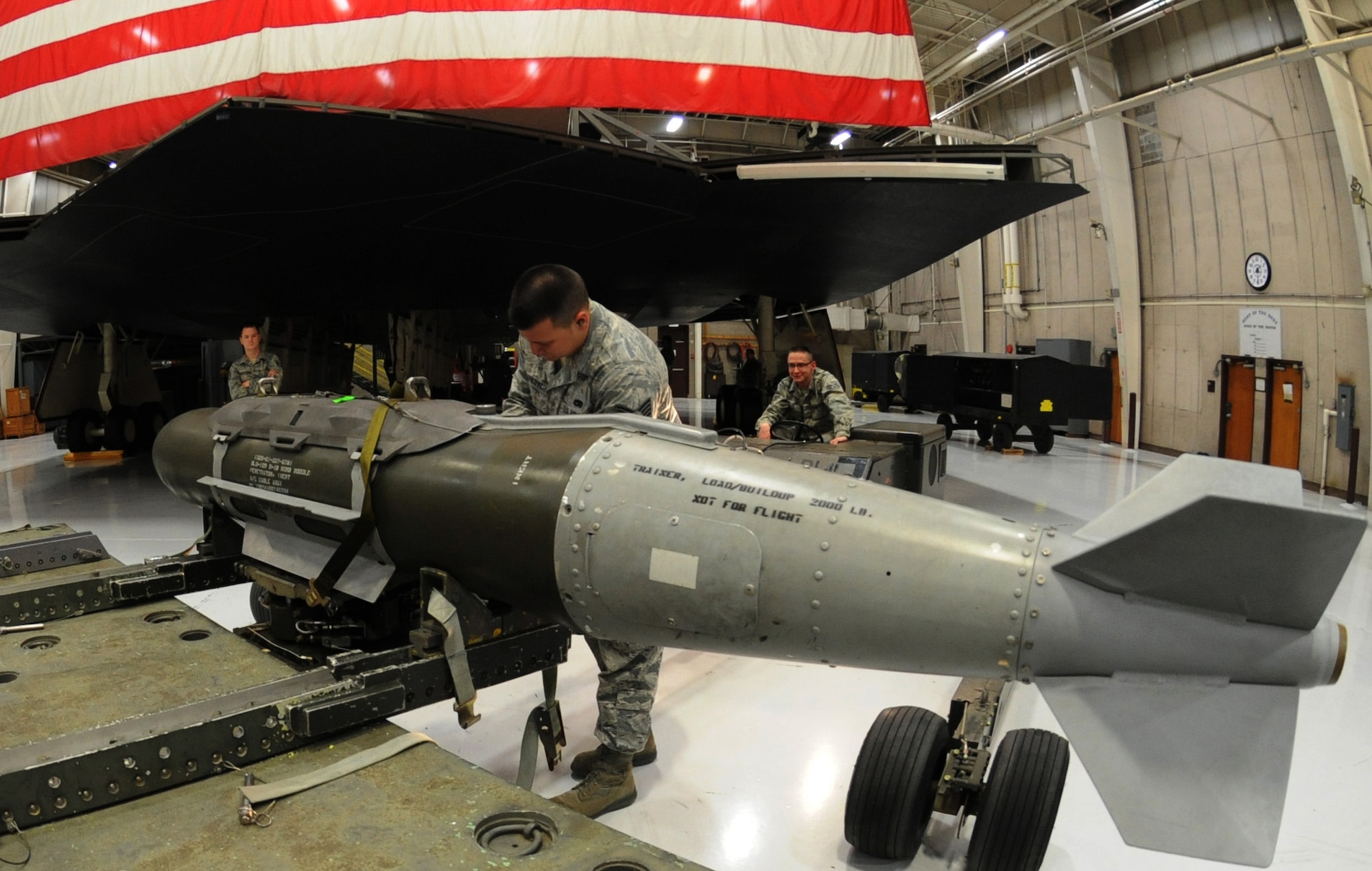 WHITEMAN AIR FORCE BASE, Mo. -- Staff Sgt. Stephan Capkovic, 131st Aircraft Maintenance Squadron load crew team member, ensures the mock GBU-31 is safely picked up by the bomb-lift truck, Jan. 25. The load crew competed in the Load Crew of the Year competition. To compete in the competition teams must win one of the four quarterly competitions. (U.S. Air Force photo/Airman 1st Class Bryan Crane)