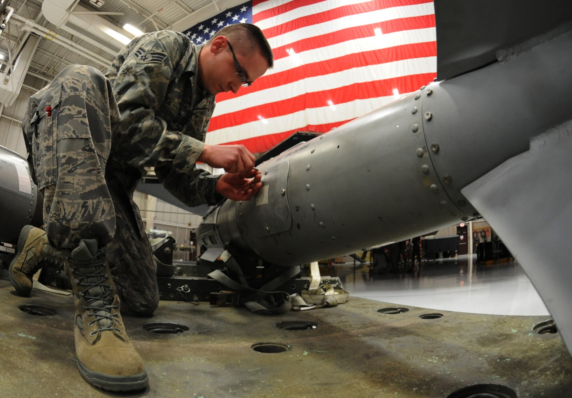 WHITEMAN AIR FORCE BASE, Mo. -- Senior Airman Jake Smith, 131st Aircraft Maintenance Squadron load crew team member, closes the fuse access cover on a mock GBU-31, Jan. 25. The load crew competed in the Load Crew of the Year competition. The winners will be announced at the 2013 Maintenance Professional of the Year banquet. (U.S. Air Force photo/Airman 1st Class Bryan Crane)