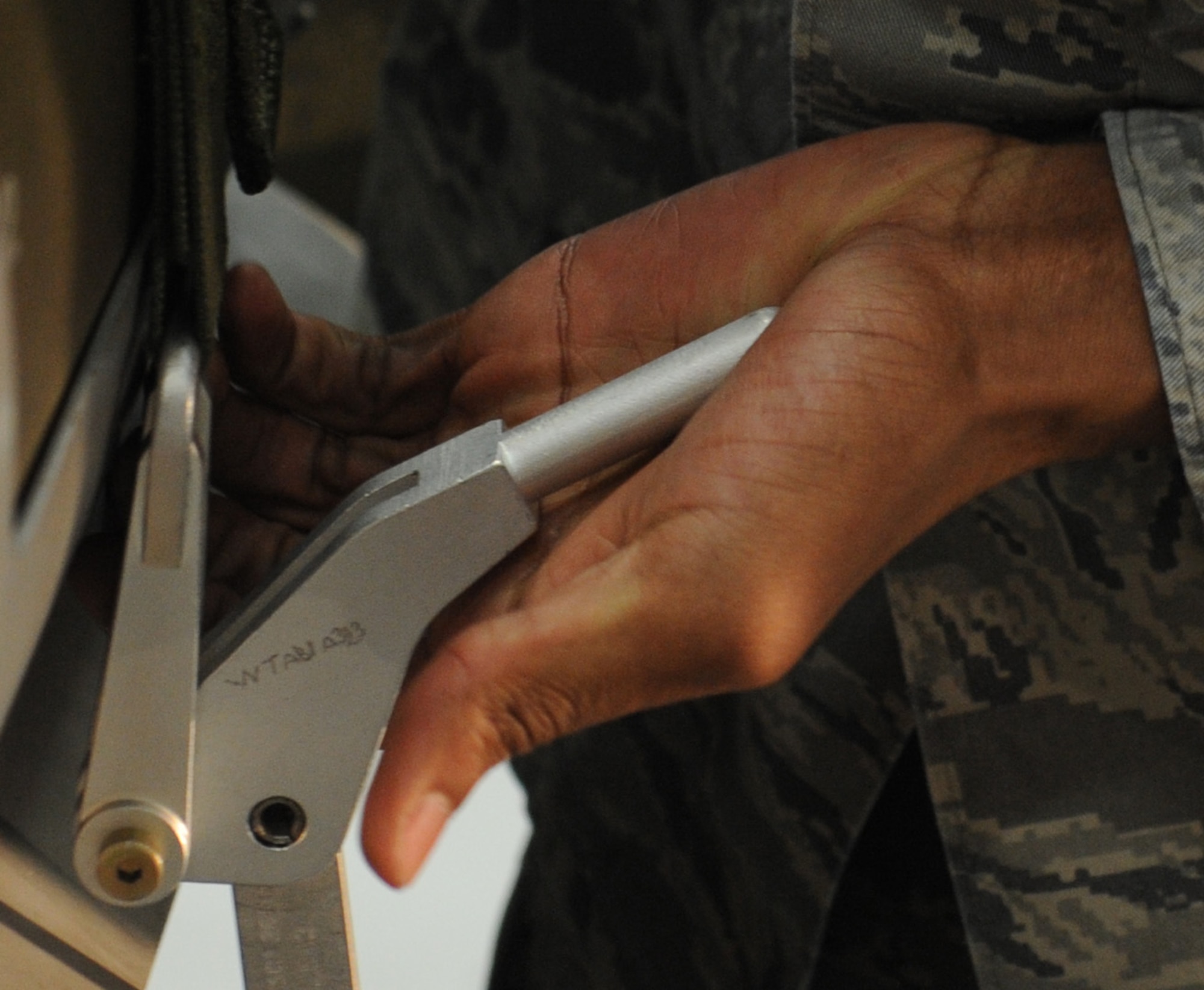 WHITEMAN AIR FORCE BASE, Mo -- Airman 1st Class Keandre Lowe, 509th Aircraft Maintenance Squadron 13th Ammunitions load crew member, secures a mock GBU-31 to the bomb lift truck, Jan. 25.  Three teams competed in the competition held at the weapons load trainer. The load crew competed in the Load Crew of the Year competition.  (U.S. Air Force photo/Airman 1st Class Bryan Crane)