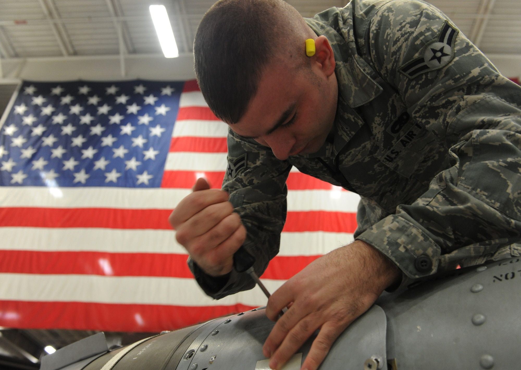 WHITEMAN AIR FORCE BASE, Mo -- Airman 1st Class Benjamin Koch, 509th Aircraft Maintenance Squadron 13th Ammunitions load crew member, closes the fuse access cover on a mock GBU-31, Jan. 25. The load crew competed in the Load Crew of the Year competition. To compete in the competition teams must win one of the four quarterly competitions. (U.S. Air Force photo/Airman 1st Class Bryan Crane)
