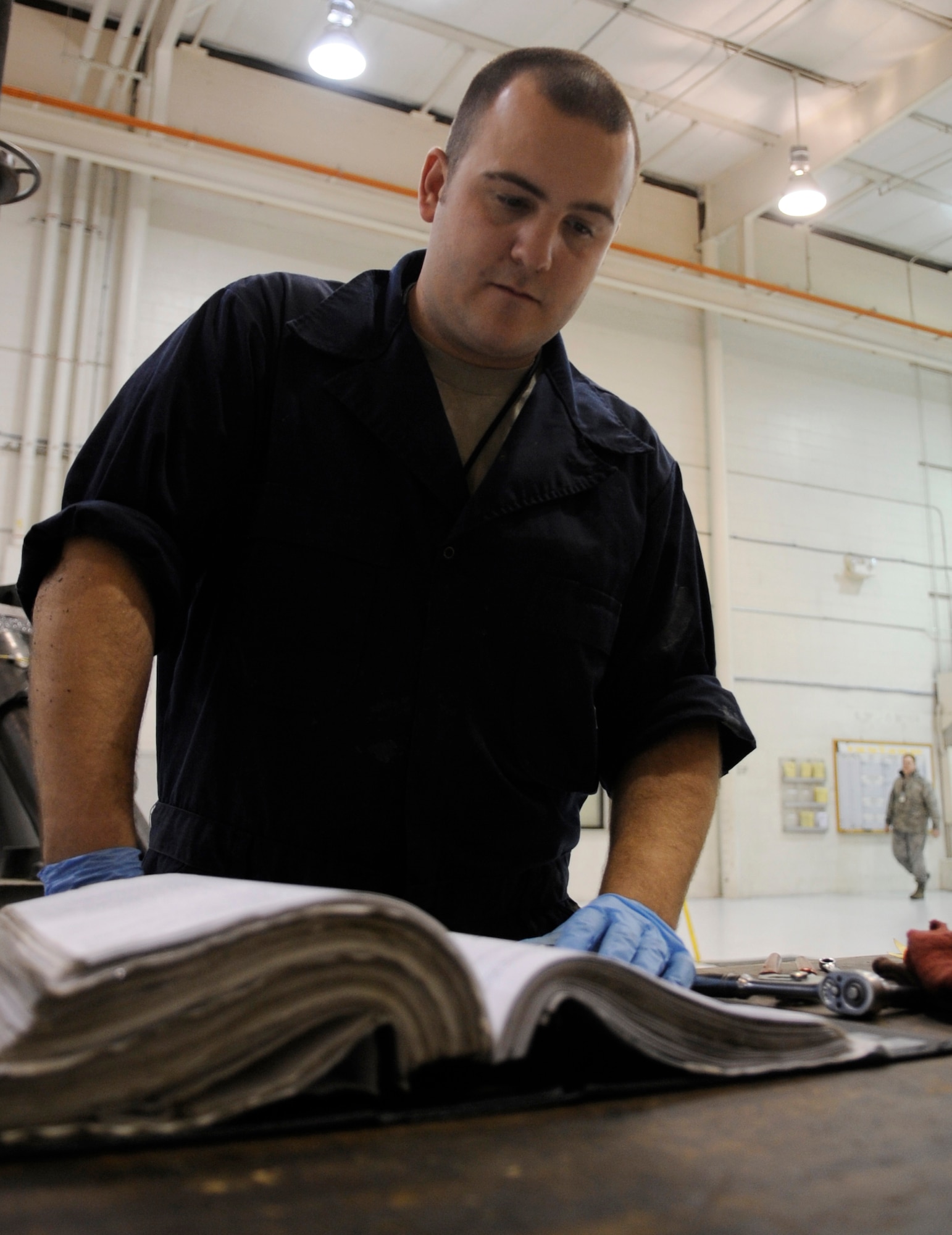 WHITEMAN AIR FORCE BASE, MO. – Staff Sgt. Cole Adams, 509th Maintenance Squadron aerospace ground equipment mechanic, references to his operating manual as he performs scheduled maintenance on equipment here Jan. 29.  The AGE flight is responsible for maintaining the equipment that supplies electricity for units on the flightline. (U.S. Air Force photo/Staff Sgt. Alexandra M. Boutte) (RELEASED) 