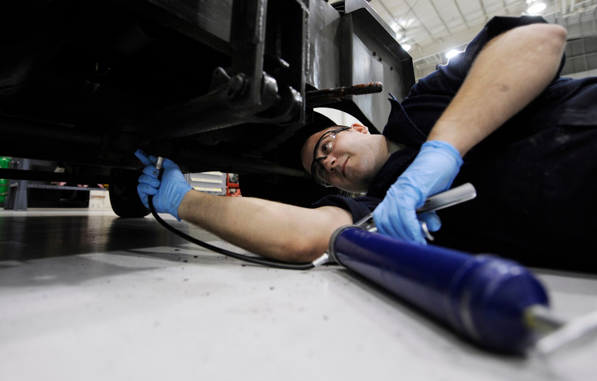 WHITEMAN AIR FORCE BASE, MO. – Staff Sgt. Cole Adams, 509th Maintenance Squadron aerospace ground equipment mechanic, applies grease to a tow tongue of the -86 diesel generator set with a grease gun here, Jan. 29. The AGE flight washes, performs inspections and lubes designated areas every six months or as directed by the technical orders to increase the longevity of the equipment. (U.S. Air Force photo/Staff Sgt. Alexandra M. Boutte) (RELEASED)