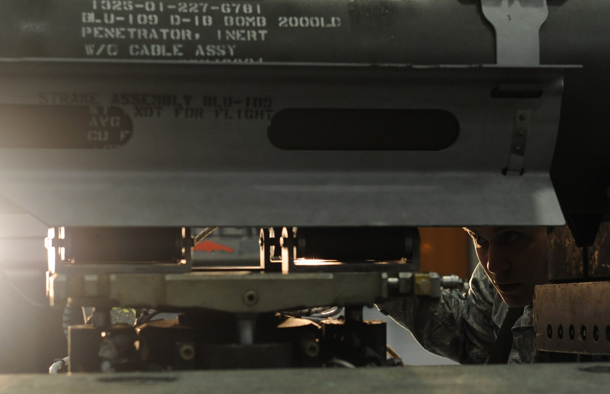 WHITEMAN AIR FORCE BASE, Mo -- Airman 1st Class Daniel Villarreal, 509th Aircraft Maintenance Squadron 393rd Amunitions load crew member, ensures the mock GBU-31 is safely picked up by the bomb lift truck, Jan. 25. The load crew competed in the Load Crew of the Year competition. The purpose of the load competition is to get the airmen to strive for excellence and to get extra time to practice handling weapons.
 (U.S. Air Force photo/Airman 1st Class Bryan Crane)
