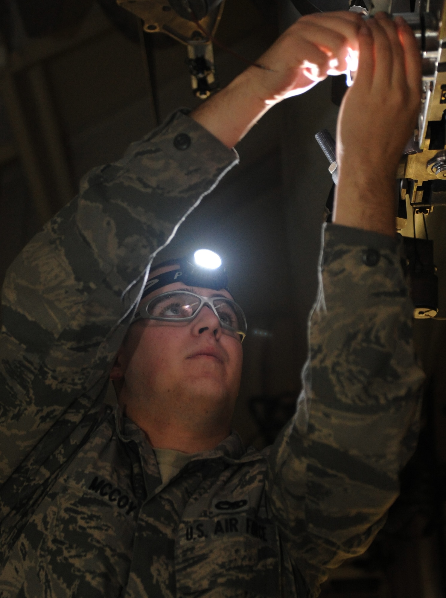 WHITEMAN AIR FORCE BASE, Mo. -- Senior Airman Joseph McCoy, 509th Aircraft Maintenance Squadron 393rd Ammunitions load crew member, prepares the bomb rack for munitions loading, Jan. 25. The load crew competed in the Load Crew of the Year competition. Three teams competed in the competition held at the weapons load trainer. (U.S. Air Force photo/Airman 1st Class Bryan Crane) (Released)