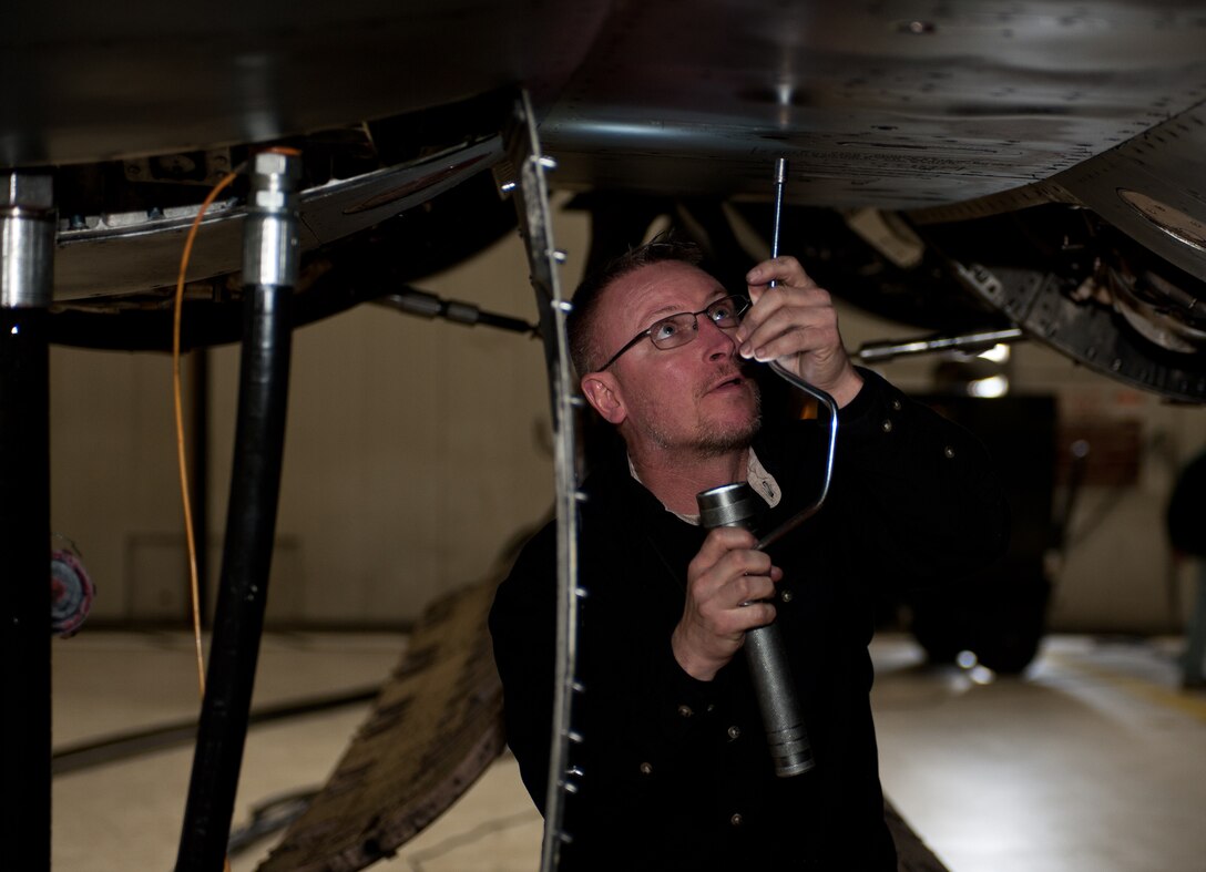 Derrick Brown, 28th Aircraft Maintenance Squadron contract field team engine mechanic, removes an access panel on a B-1 during a home station maintenance check at Ellsworth Air Force Base, S.D., Jan. 22, 2013. The panel was removed to inspect the wheel auxiliary power unit area for leaks, wear and tear and missing hardware. (U.S. Air Force photo by Airman 1st Class Alystria Maurer/Released)