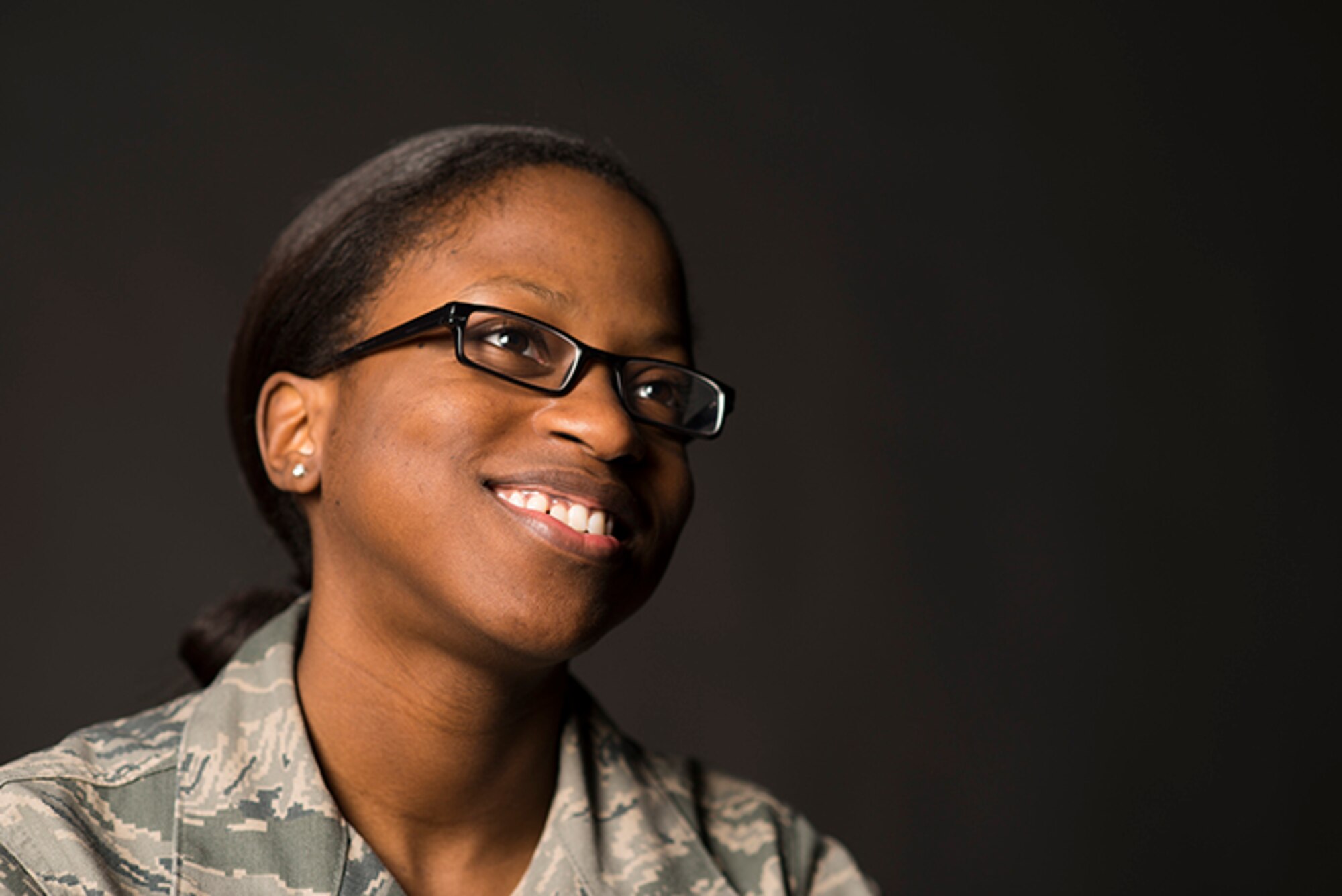 Airman 1st Class Mimi Greasham, a 19th Comptroller Squadron financial technician, smiles during an interview Feb. 1, at Little Rock Air Force Base. Greasham, who came from a single-parent home, said she overcame many obstacles and wants to be a light for her community. (U.S. Air Force photo by Staff Sgt. Russ Scalf) 