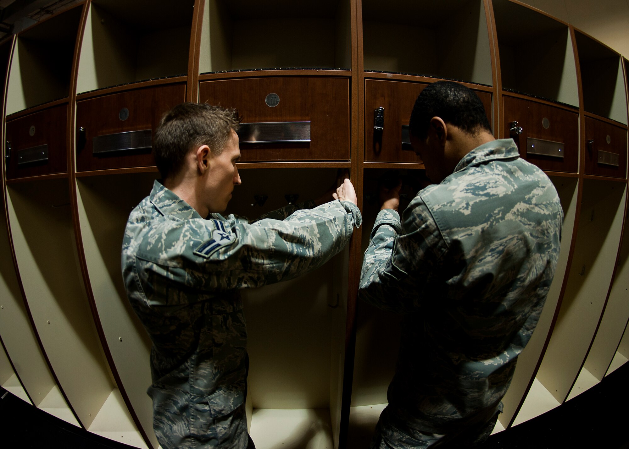 Airman 1st Class Raylan Marcontell, left, and Airman 1st Class Amir Wallace, right, 7th Operations Support Squadron assemble aircrew equipment lockers Jan. 31, 2013, as part of an aircrew flight equipment consolidation project at Dyess Air Force Base, Texas. Airmen from the 7th OSS consolidated more than 280 aircrew equipment lockers into one facility as part of a consolidation project. The project brought the oxygen section and flightline section of aircrew flight equipment into one facility. Contractors projected that the consolidation would cost the Air Force between $15,000 and $20,000, but 7th OSS Airmen completed the job for much less. Thanks to the large number of Airmen who volunteered to help, the project was completed in under a week. (U.S. Air Force photo by Airman 1st Class Damon Kasberg/ Released)