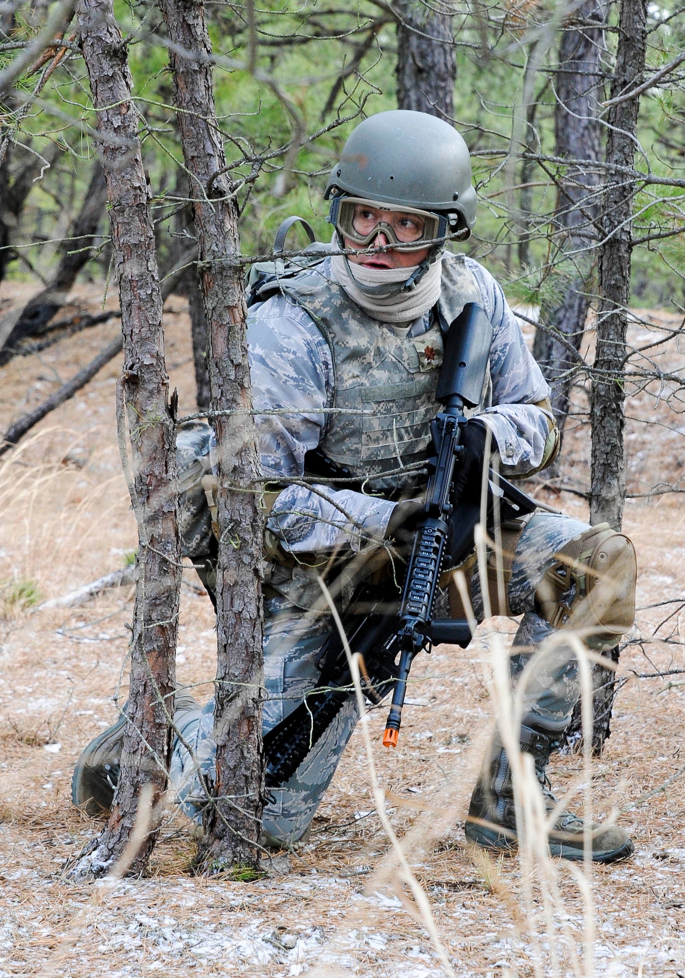 An Air Advisor Academy student covers his fellow wingmen as they make their way through the wooded area behind the village Feb. 1, 2013, on the ranges at Joint Base McGuire-Dix-Lakehurst, N.J., as part of their field training exercise. The students tactically moved through the wooded area behind the village to their designated landing zone all the while receiving fire from advancing enemy personnel. (U.S. Air Force photo by Airman 1st Class Ryan Throneberry/Released)