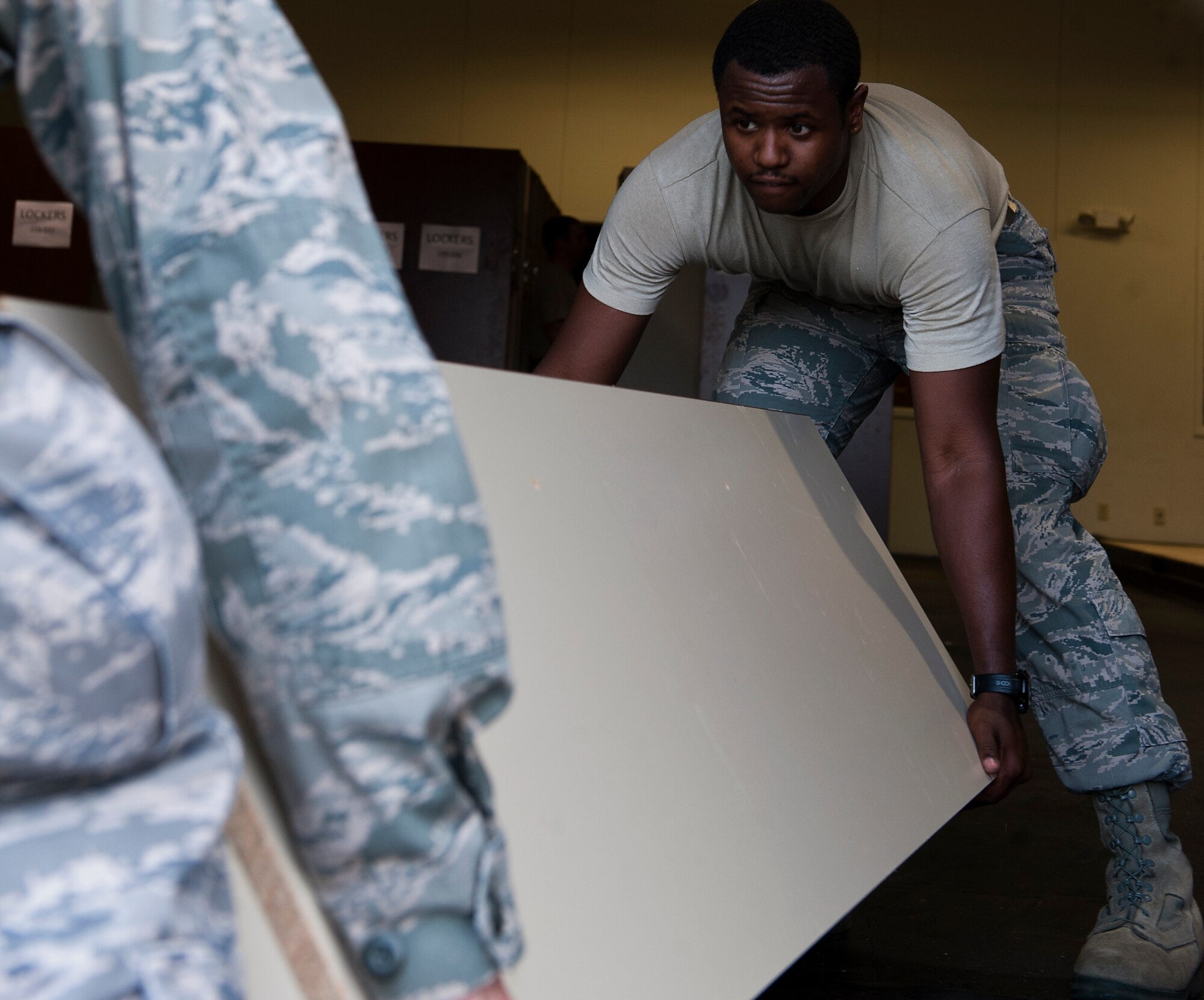 Airman 1st Class Michael C. Thomas, 7th Operations Support Squadron, helps move a locker into its new location as part of a consolidation project, Jan. 29, 2013, at Dyess Air Force Base, Texas. The project brought the oxygen and flightline sections of aircrew flight equipment into one facility. Contractors projected that the consolidation would cost the Air Force between $15,000 and $20,000, but 7th OSS Airmen completed the job for much less. Thanks to the large number of Airmen who volunteered to help, the project was completed in under a week. (U.S. Air Force photo by Airman 1st Class Damon Kasberg/ Released)