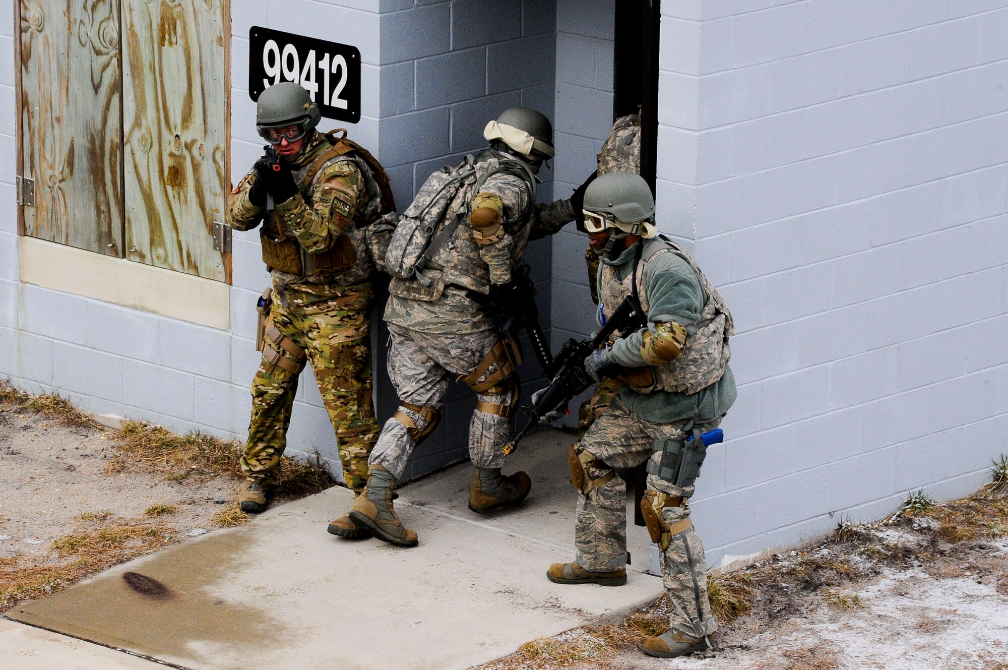Air Advisor Academy students enter a building for cover against enemy fire Feb. 1, 2013, on the ranges at Joint Base McGuire-Dix-Lakehurst, N.J., as part of their field training exercise. The range facilities replicate an urban environment students may encounter downrange. (U.S. Air Force photo by Airman 1st Class Ryan Throneberry/Released)