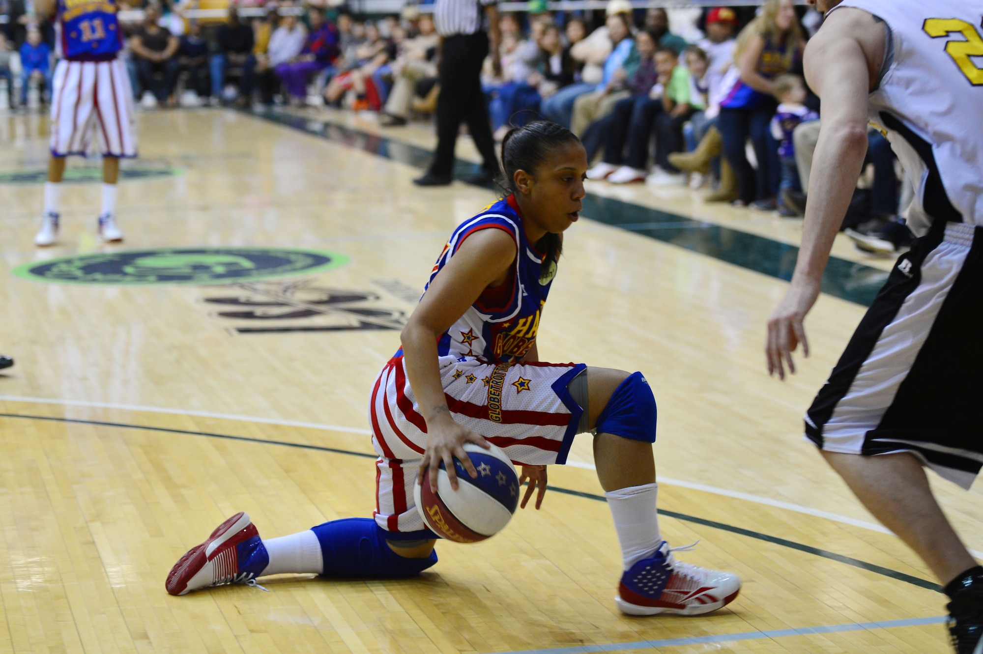 Mighty Mitchell, rookie guard for the Harlem Globetrotters, shows off her dribbling skills during a basketball game at the Greyhound Arena in Portales, N.M., Feb. 5, 2013.The Harlem Globetrotters offered a crowd of several hundred people a comical, energy-packed game.(U.S. Air Force photo/Airman 1st Class Eboni Reece)