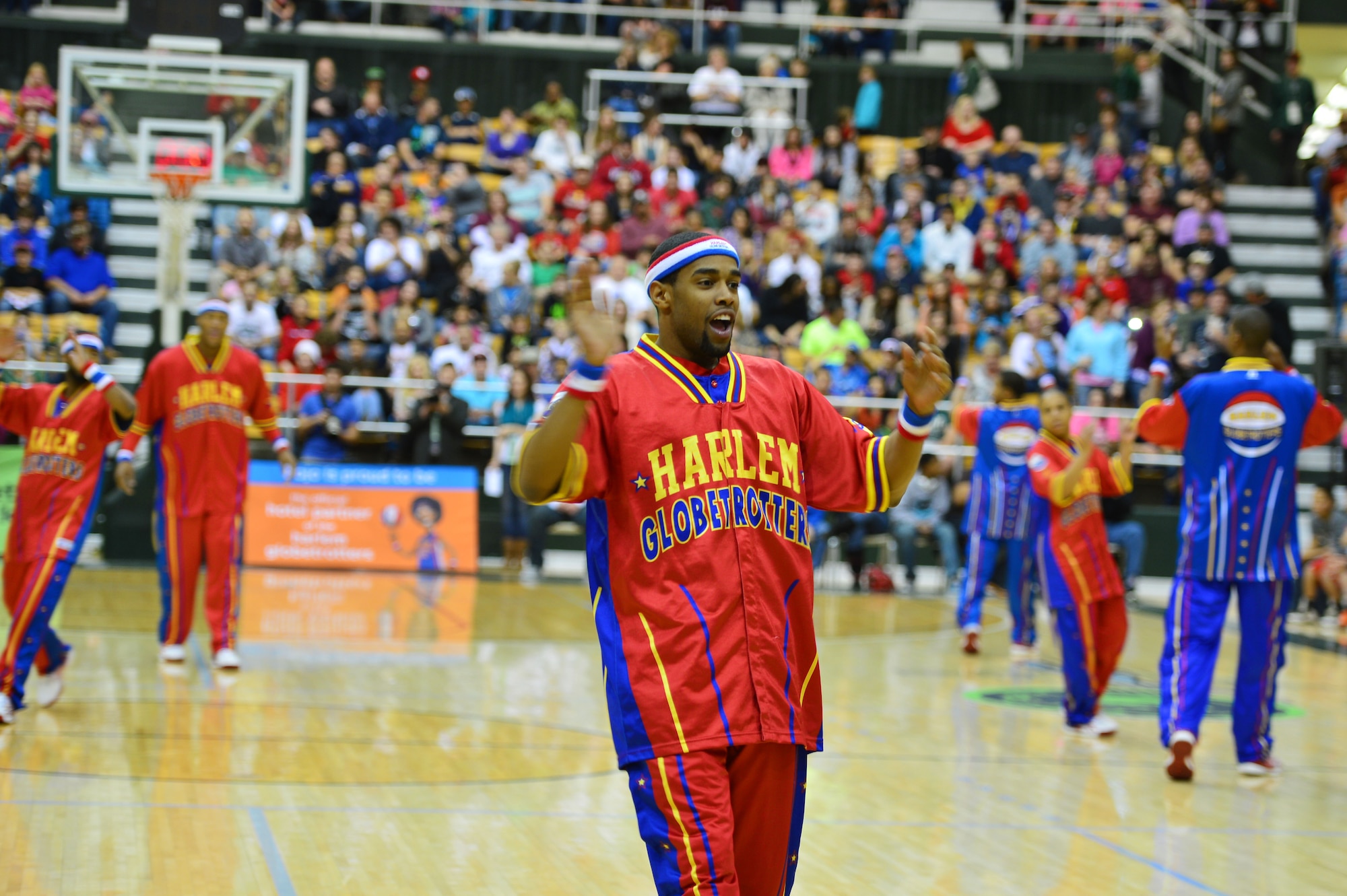Cheese Chisolm, guard for the Harlem Globetrotters, claps during pre-game activities at the Greyhound Arena in Portales, N.M., Feb. 5, 2013. The Harlem Globetrotters offered a crowd of several hundred people a comical, energy-packed game. (U.S. Air Force photo/Airman 1st Class Eboni Reece)