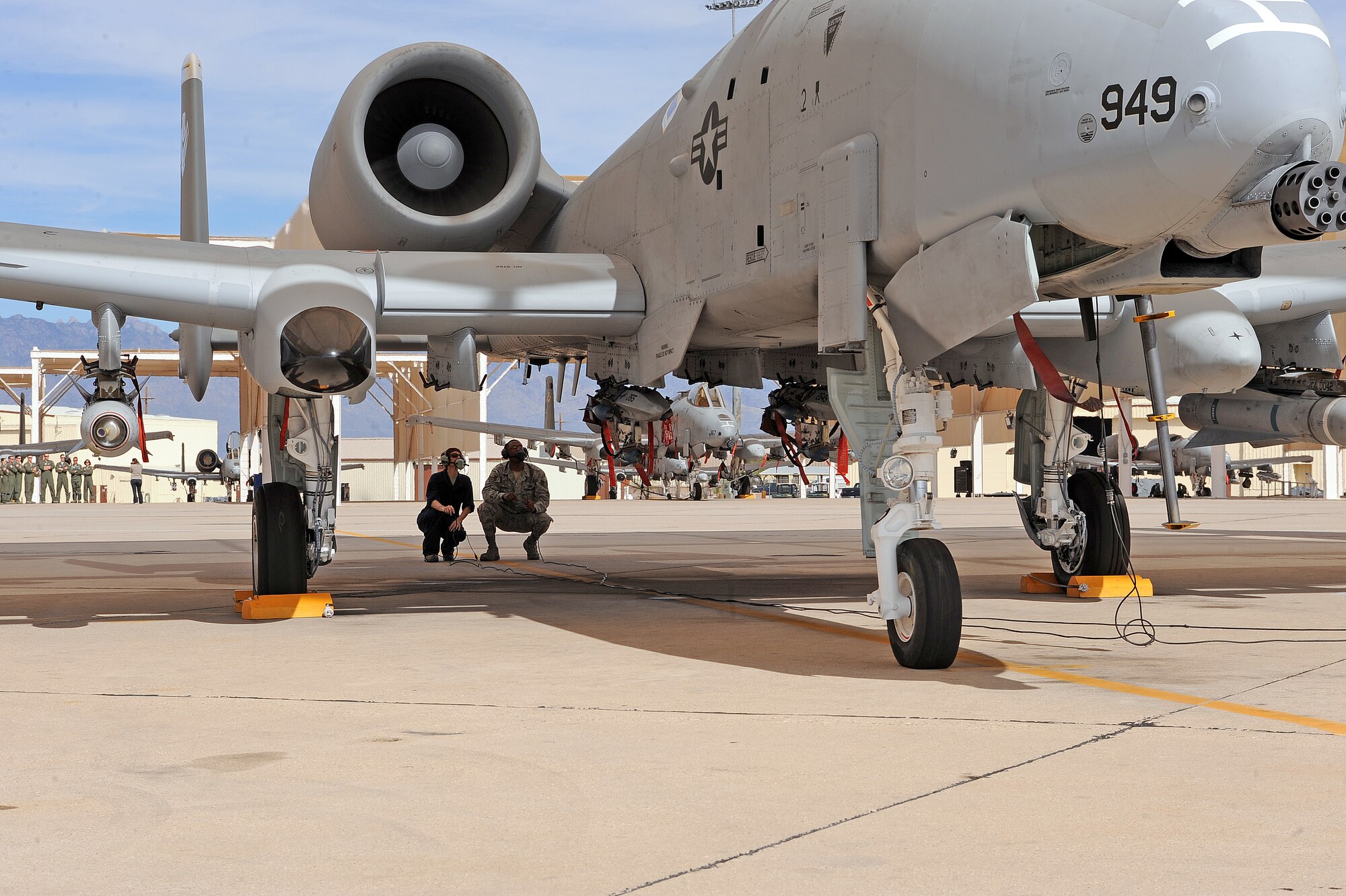 U.S. Air Force Chief Master Sgt. Dawna Cnota, 355th Fighter Wing command chief master sergeant, and Staff Sgt. Kyle Pickens, 355th Aircraft Maintenance Squadron, inspect the A-10 aircraft prior to Col. James Meger, 355th Fighter Wing vice commander, takes off on the flightline on Davis-Monthan Air Force Base, Ariz. Feb. 4, 2013. A crew chief's technical training school is approximately six-months long. The training covers anything from maintenance to the structure of the aircraft.  (U.S. Air Force photo by Airman 1st Class Christine Griffiths/Released)