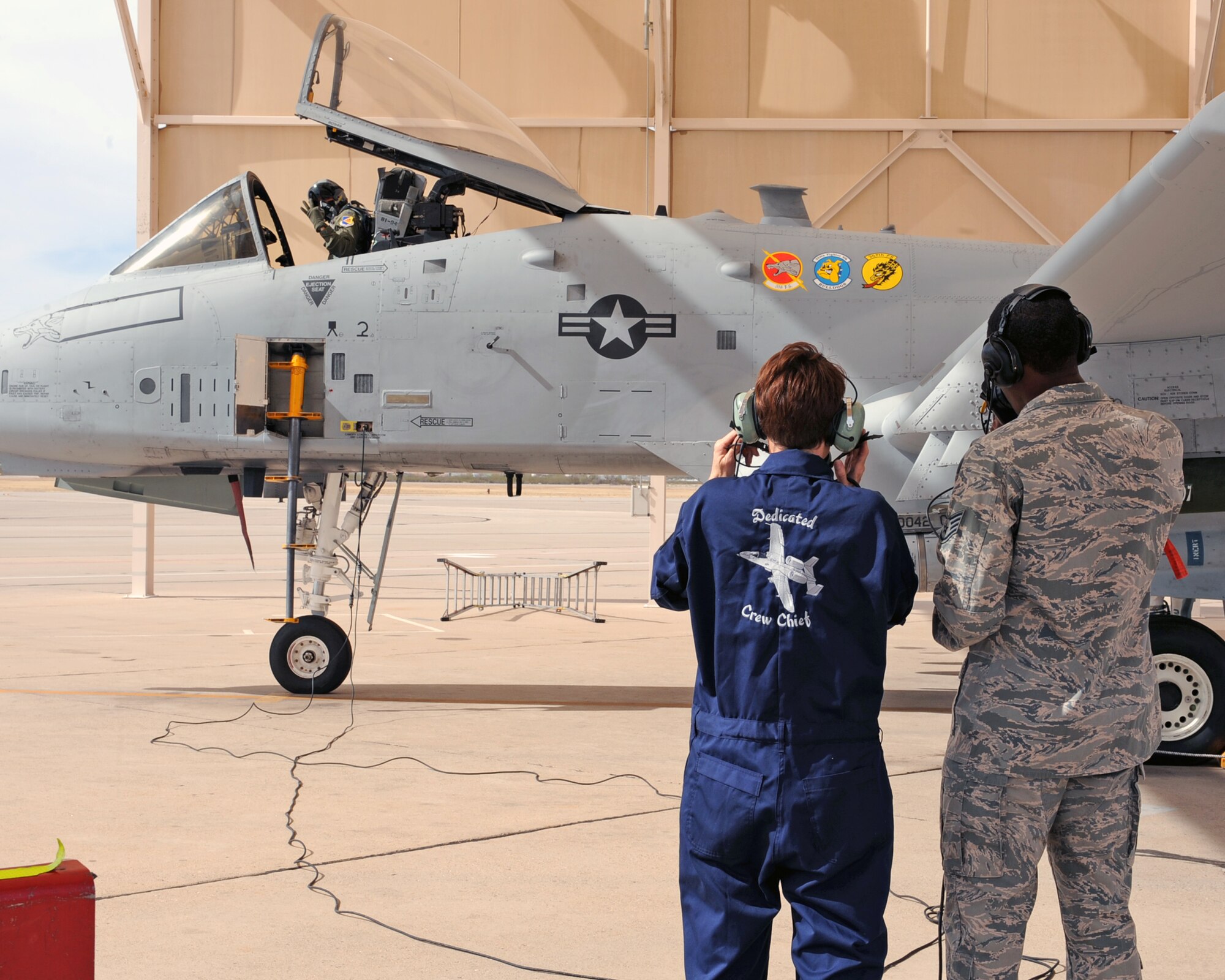 U.S. Air Force Staff Sgt. Kyle Pickens, 355th Aircraft Maintenance Squadron, shows Chief Master Sgt. Dawna Cnota, 355th Fighter Wing command chief master sergeant, the ropes of being an A-10 aircraft crew chief on the flightline on Davis-Monthan Air Force Base, Ariz. Feb. 4, 2013. Crew chiefs repair, inspect and ensure the aircraft is in proper condition before and after flight. (U.S. Air Force photo by Airman 1st Class Christine Griffiths/Released)