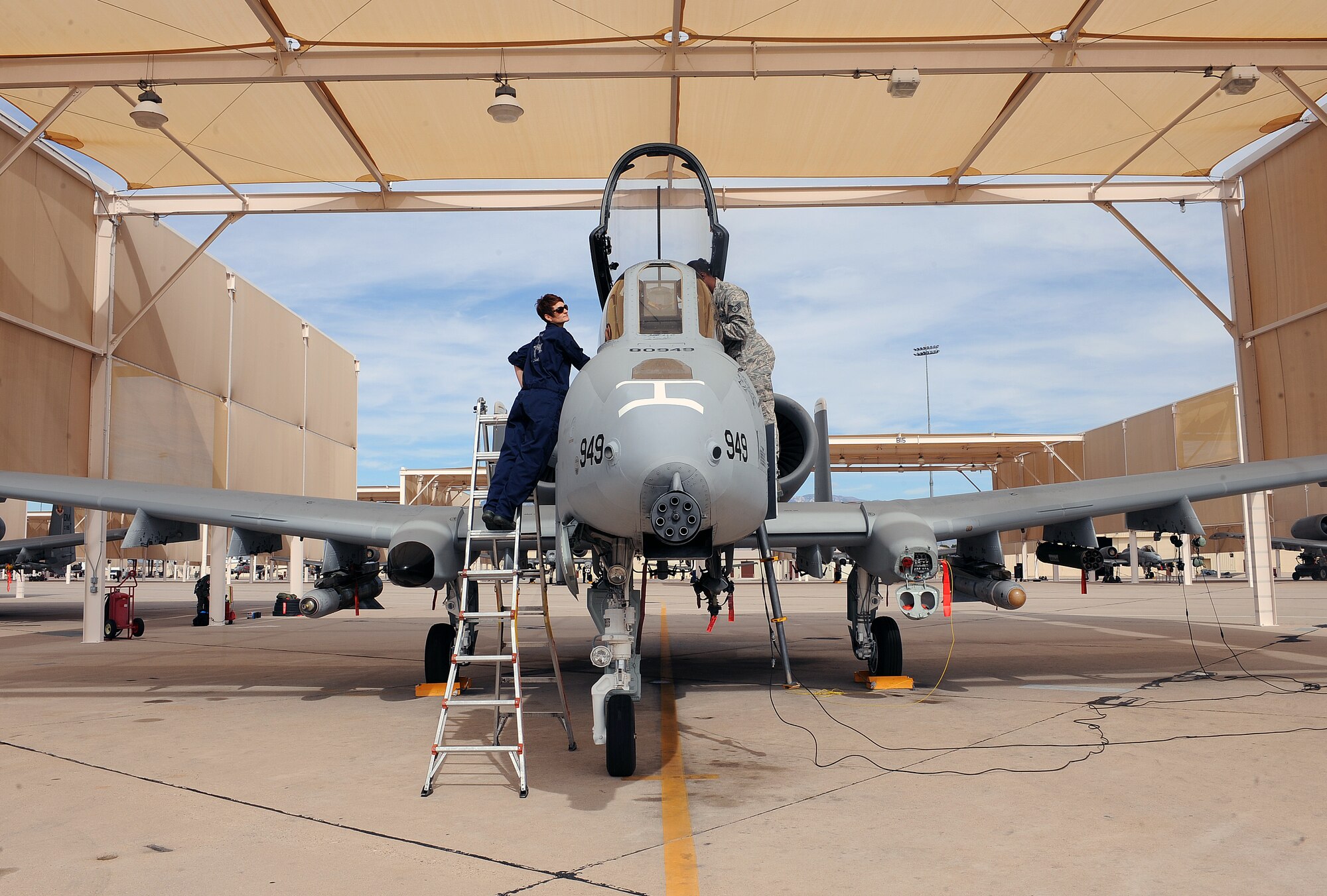 U.S. Air Force Chief Master Sgt. Dawna Cnota, 355th Fighter Wing command chief master sergeant, and Staff Sgt. Kyle Pickens, 355th Aircraft Maintenance Squadron, perform pre-flight checks on the flightline on Davis-Monthan Air Force Base, Ariz. Feb. 4, 2013. A crew chief's technical training school is approximately six-months long. The training covers anything from maintenance to the structure of the aircraft. (U.S. Air Force photo by Airman 1st Class Christine Griffiths/Released)