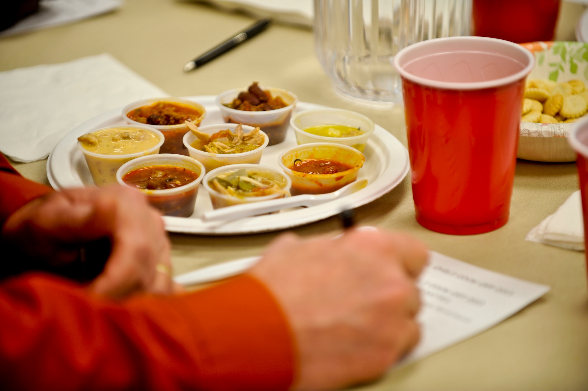 Duane Judy, 460th Space Wing Anti-terrorism Office, takes notes on chili entries at the 10th Annual Chili Cook-Off hosted by the Buckley Air Force Base Chapel Feb. 6, 2013, at the chapel Fellowship Hall. Judy was one of six judges.  The judges were presented with 16 types of chili, nearly double last year’s submissions. (U.S. Air Force photo by Airman 1st Class Riley Johnson/Released)