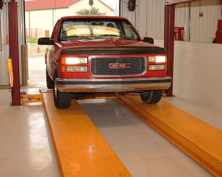 A customer drives his truck onto a lift at the Auto Hobby Shop on Barksdale Air Force Base, La., Feb. 7. The lift is used to help customers perform maintenance on their car. (U.S. Air Force photo/Senior Airman Sean Martin)