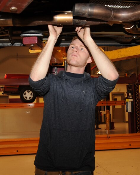 Senior Airman John Aubuchon, 2nd Aircraft Maintenance Squadron communication navigation journeyman, attaches a catback exhaust to his car at the Auto Hobby Shop on Barksdale Air Force Base, La., Feb. 7. The shop gives base personnel a place to work on their vehicles providing all the essentials tools.  (U.S. Air Force photo/Senior Airman Sean Martin)