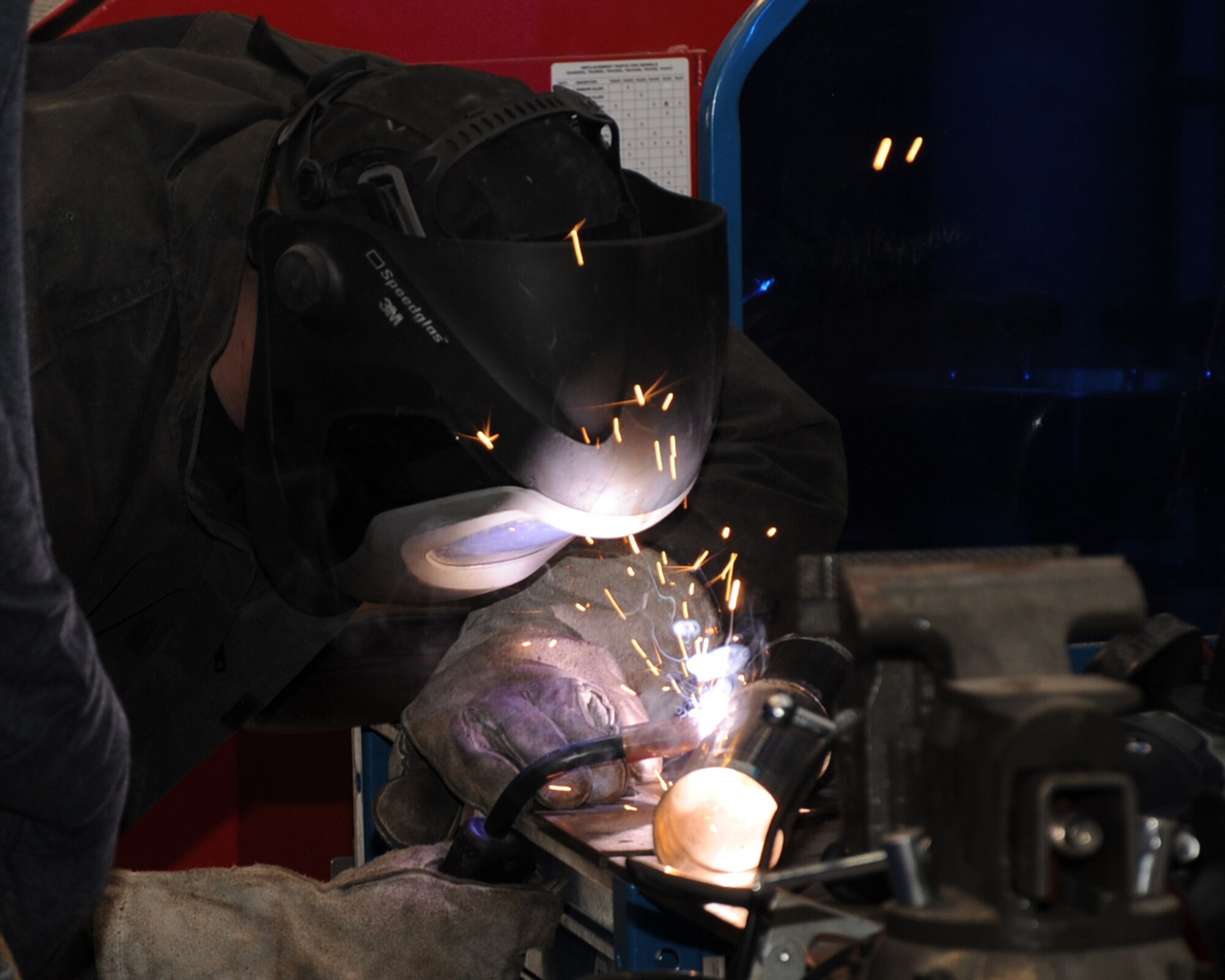 Senior Airman Timothy Moore, 2nd Maintenance Squadron electrical environmental journeyman, welds part of catback exhaust at the Auto Hobby Shop on Barksdale Air Force Base, La., Feb. 7. The shop gives base personnel a place to work on their vehicles providing all the essentials tools.  (U.S. Air Force photo/Senior Airman Sean Martin)