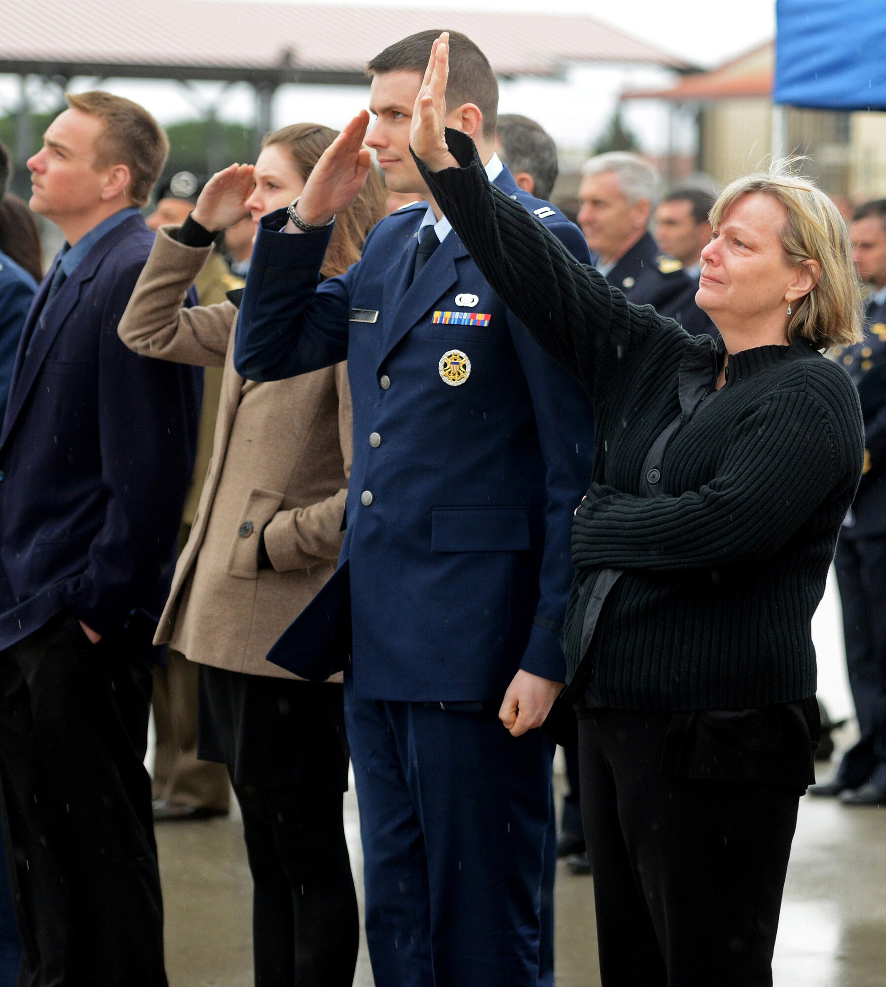 Romel Mathias, the mother of Maj. Lucas Gruenther, waves as a formation of F-16 Fighting Falcons flies over Aviano Air Base, Italy, Feb. 6, 2013. The flyover was part of a memorial service for Gruenther, who lost his life when his F-16 went down during a training mission Jan. 28. (U.S. Air Force photo/Staff Sgt. Justin Weaver)
