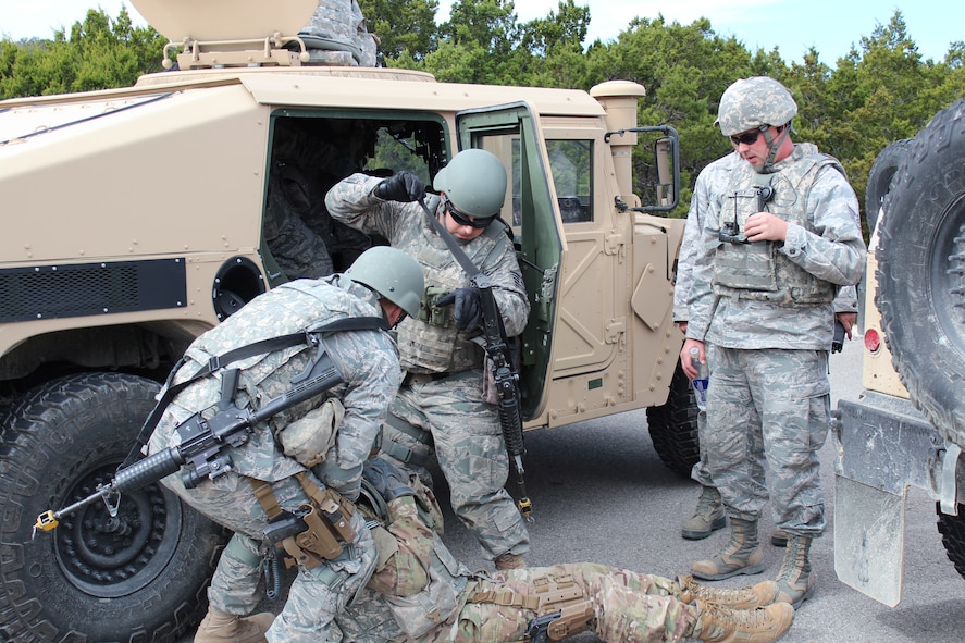 Staff Sgt. Joshua Casey, Combat Airman Skills Training instructor, watches as students of a CAST class conduct the transfer of simulated patients from one vehicle to another, Feb. 5, 2013 at Camp Anderson-Peters, Texas. Attending CAST requires each member to be physically fit as the course is very demanding. (U.S. Air Force photo/Tech. Sgt. Jason Wells)