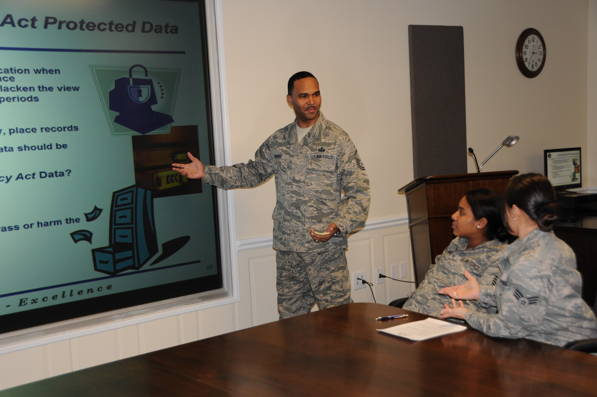 Master Sgt. Anthony Harris, an air reserve technician with the 512th Communications Operations Flight, conducts Privacy Act awareness training to Staff Sgt. Lorraine Almanza and Senior Airman Tatiana Baines, 512th Force Support Squadron, Feb. 7, 2013, in the 512th Airlift Wing Headquarters building, Dover Air Force Base, Del. Harris has performed several jobs since becoming an ART in 2007, to include records manager, publications manager, and currently knowledge operations fucntional manager. (U.S. Air Force photo/Senior Airman Joe Yanik)