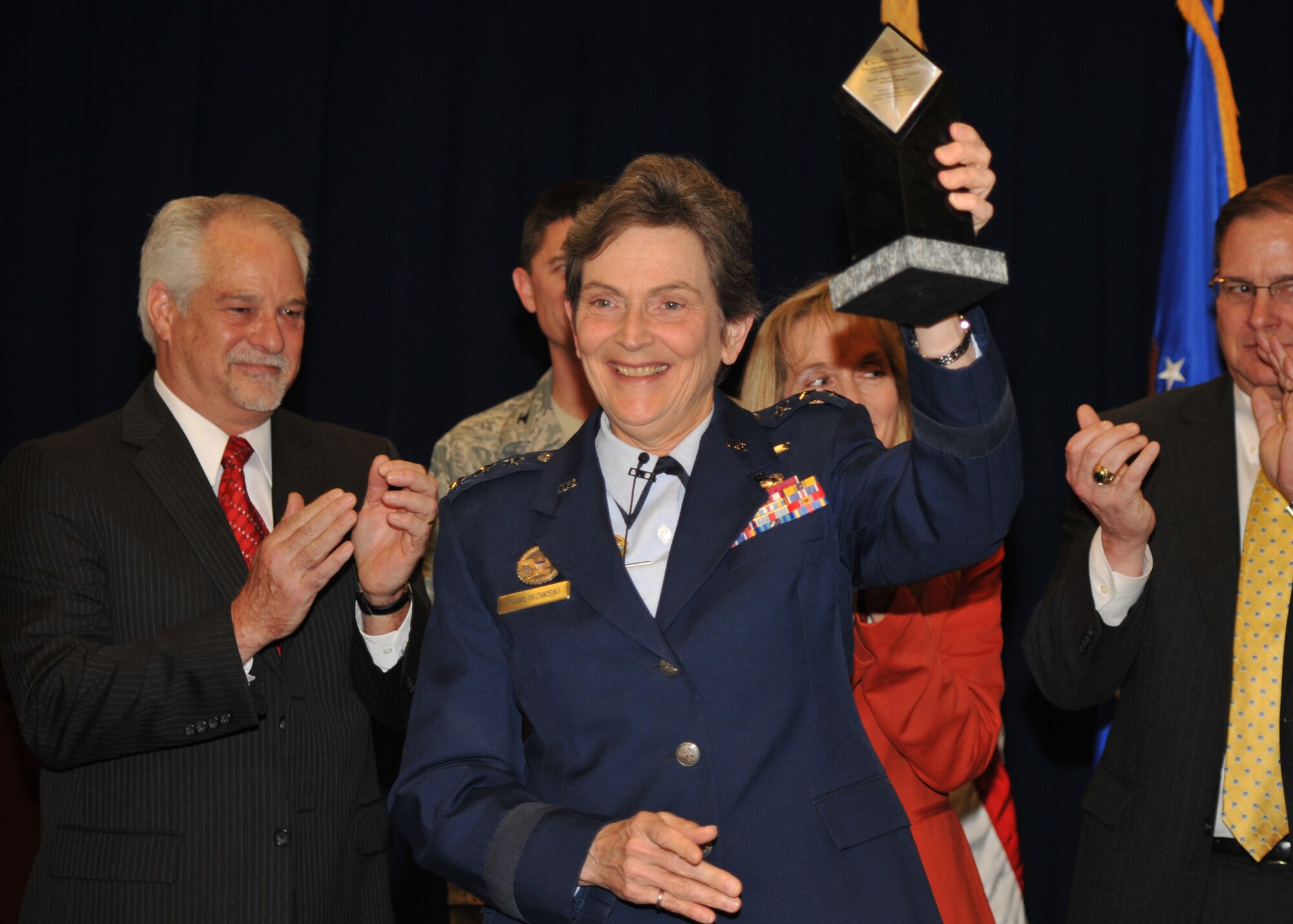 Lieutenant General Ellen Pawlikowski, Space and Missiles Systems Center commander, shows off the Aviation Week Program Excellence award after accepting it on behalf of SMC.  The Commercially Hosted Infrared Payload team, comprised of government and industry partners, won the subsystem level award from the magazine in November 2012.  The team presented the award to the center, Feb 1. (Photo by Sarah Corrice)