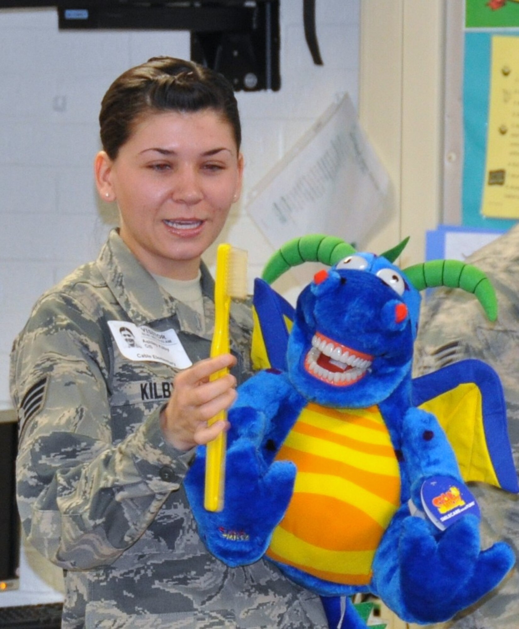 Staff Sgt. Ashley Kilby, a 433rd Aerospace Medicine Squadron dental assistant, begins a teeth-brushing demonstration to kindergarteners at Cable Elementary School in San Antonio, Texas on Feb. 7, 2013.  Airmen from the 433rd AMDS gave three presentations about dental hygiene to roughly 120 students. (U.S. Air Force Photo/Tech Sgt. Carlos J. Trevino)
