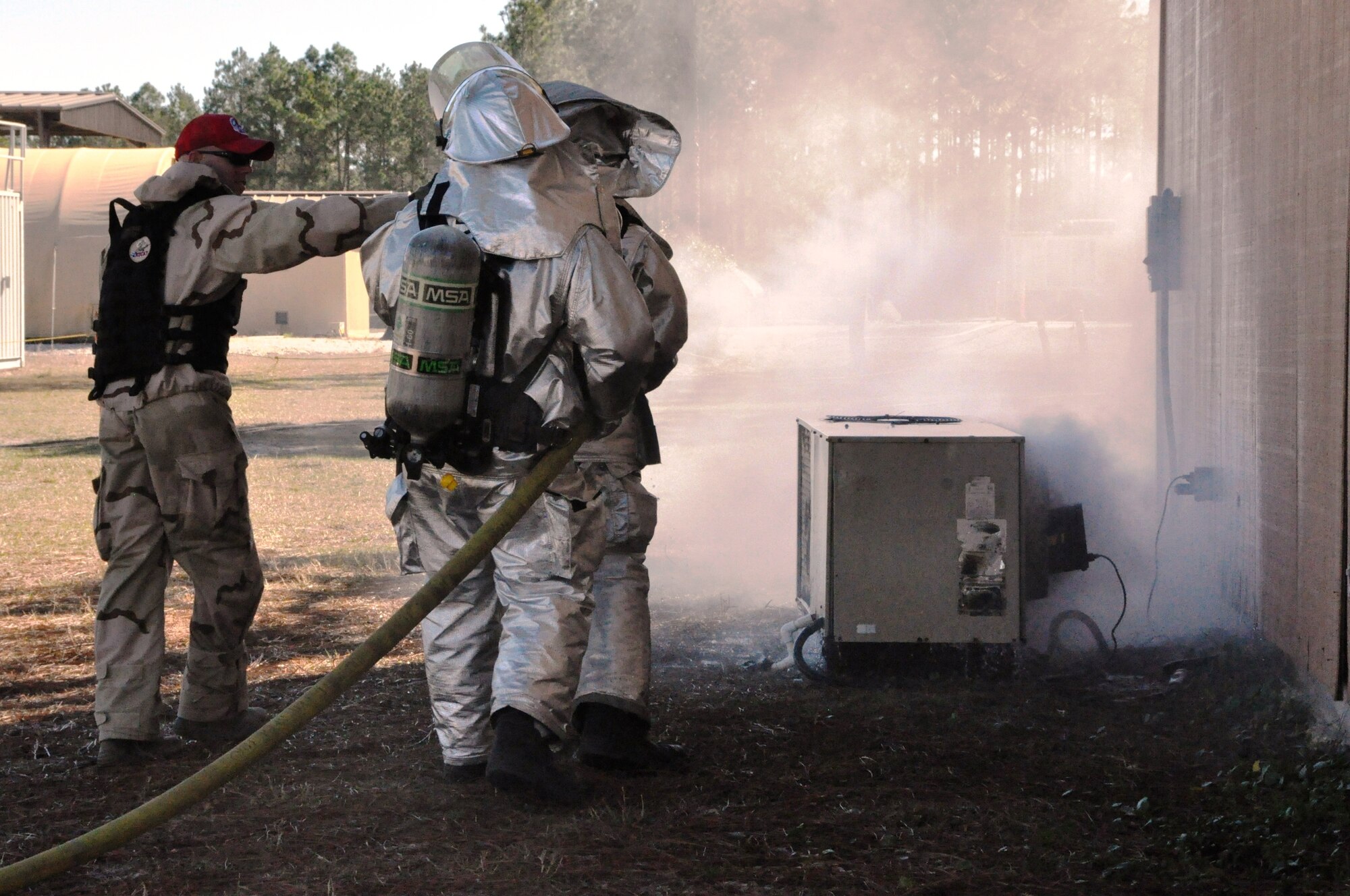 Firefighters participating in the 823rd RED HORSE Squadron Silver Flag fire training prepare to extinguish an H-VAC fire. (U.S. Air Force photo by Staff Sgt. Rachelle Elsea)