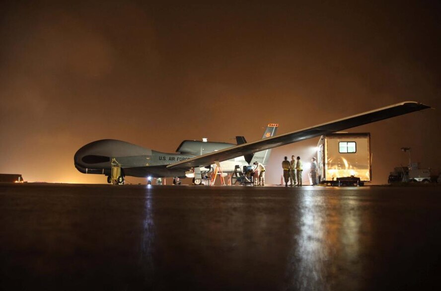 13 RS Reservists, of the 940th Wing from Beale Air Force Base, Calif.  perform pre-flight inspections before launching the Global Hawk at Guam Air Force Base, Guam. The Beale Reservists launched and recovered the air craft for real world missions in the Pacific Command during their annual training requirement. (U.S. Air Force Photo/ TSgt Kenny McCann)