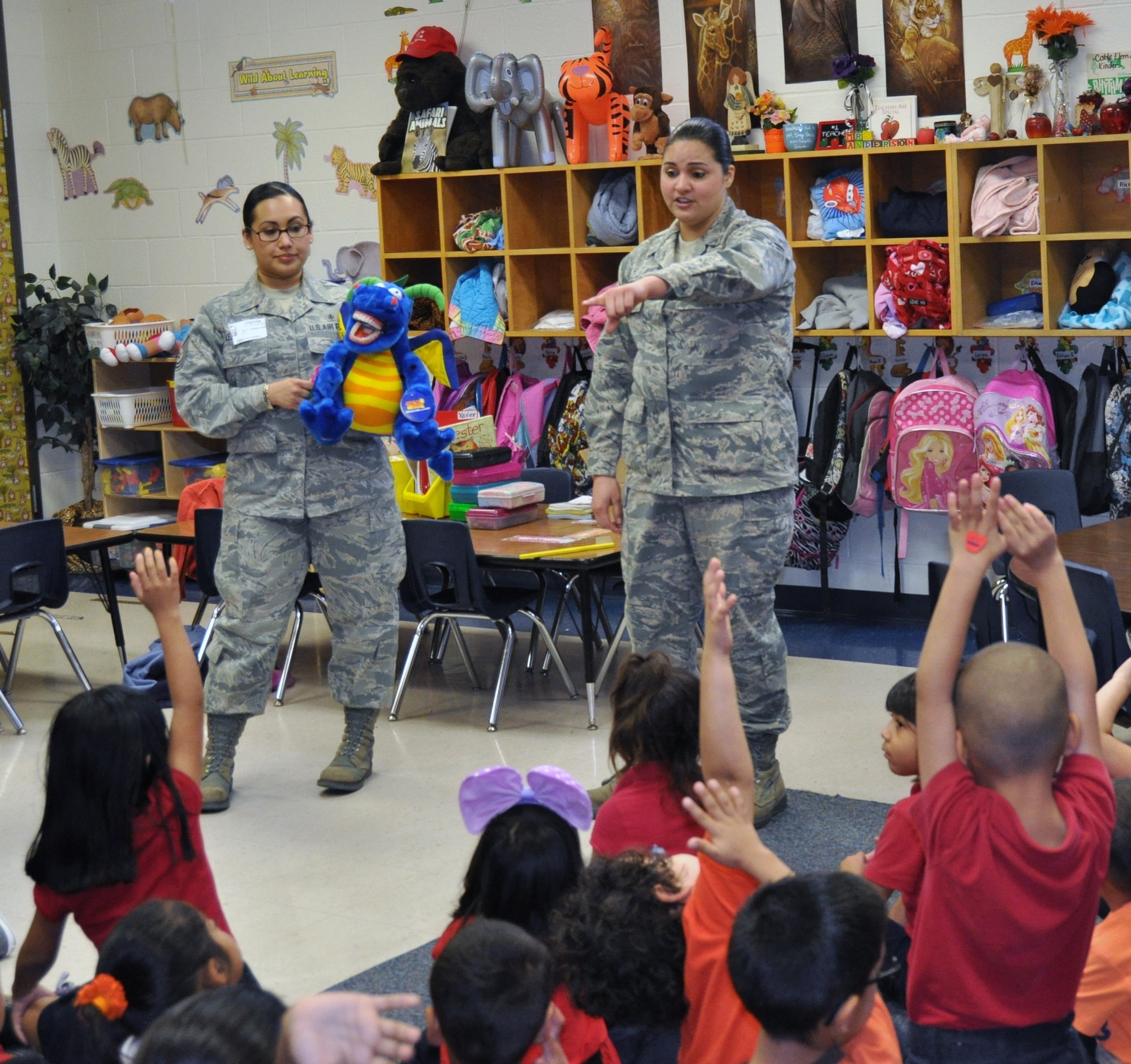 Senior Airman Samantha Crawford and Tech. Sgt. Betty Alejandrez, 433rd Aerospace Medicine Squadron dental assistants, answer questions about dental hygiene during a visit to Cable Elementary in San Antonio, Texas on Feb. 7, 2013. Airmen from the 433rd AMDS gave three presentations on how to maintain good oral hygiene through brushing, flossing and healthy snack choices to over 120 kindergarteners. (U.S. Air Force Photo/Tech Sgt. Carlos J. Trevino)