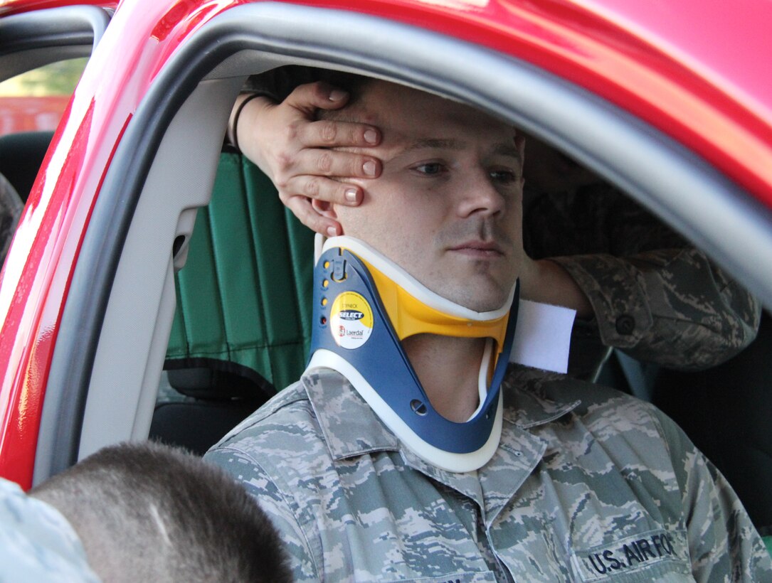 Staff Sgt. Dexter McElhiney holds still after spending more than ten minutes in a neck brace that was used during a trauma scenario conducted by the 932nd Medical Squadron recently. Several 932nd MDS members drilled on removing simulated accident victims from vehicles.  The 932nd MDS conducts a variety of medical trauma scenarios for its members to maintain their core skills. (U.S. Air Force photo/Tech. Sgt. Daniel Oliver)