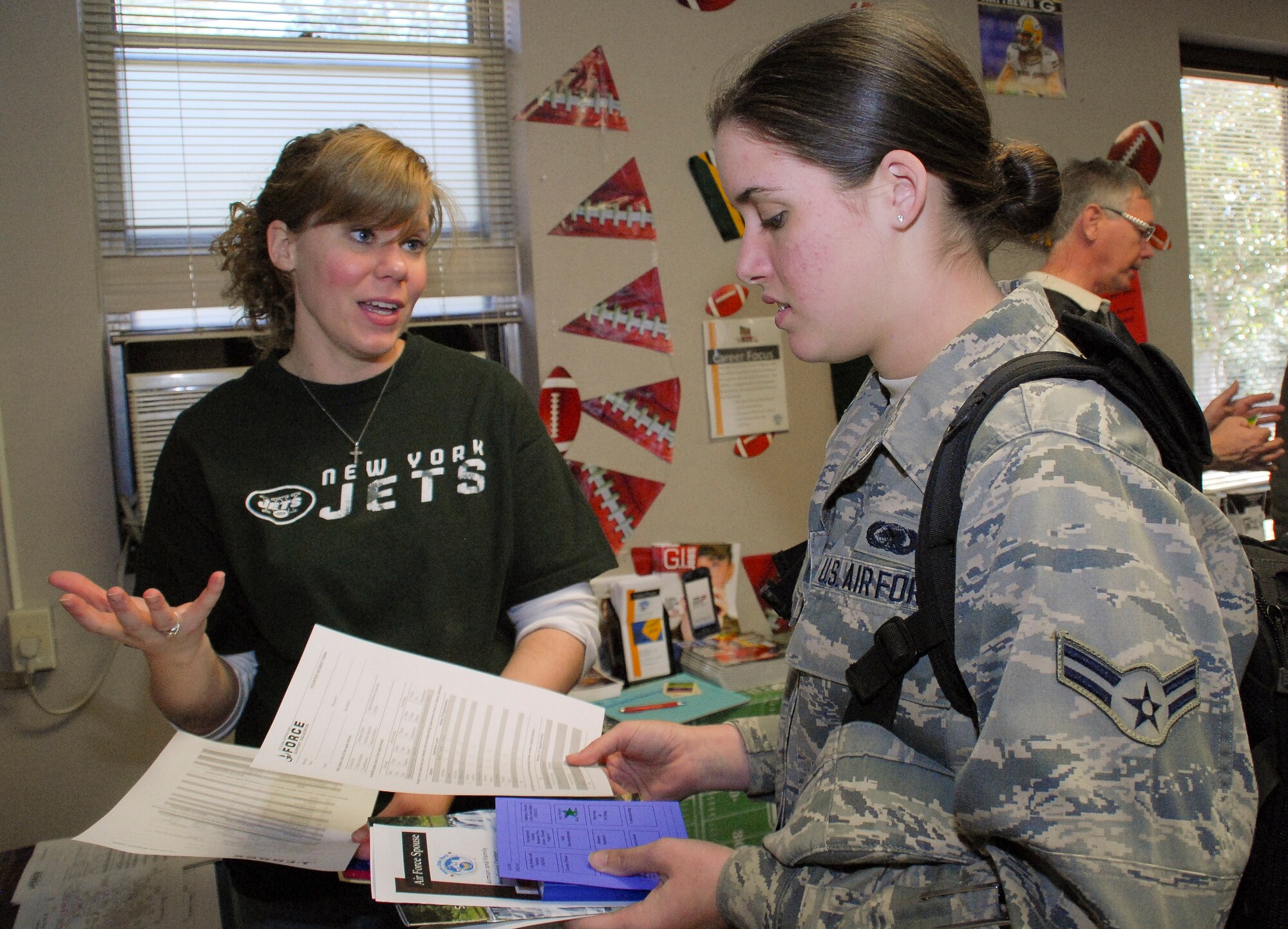 Andrea Perkins, a 19th Force Support Squadron community readiness consultant, tells Airman 1st Class Alexis Self, 19th Logistic Readiness Squadron, about volunteer opportunities at Little Rock Air Force Base, Ark., Feb. 1, 2013, at the Airman and Family Readiness Center. The AFRC held an open house, showing off more than 20 of their revamped programs to Team Little Rock members who attended. (U.S. Air Force photo by Staff Sgt. Jacob Barreiro)