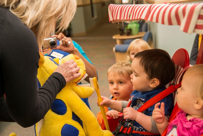 Gaye Adams, 628th Medical Group chief of preventive dentistry, shows children how to brush teeth during Children’s Dental Health Month Feb. 5, 2013, at the Child Development Center at Joint Base Charleston – Air Base. Members from the 628th Medical Group taught children the importance of taking care of their teeth. (U.S. Air Force photo/Senior Airman George Goslin)