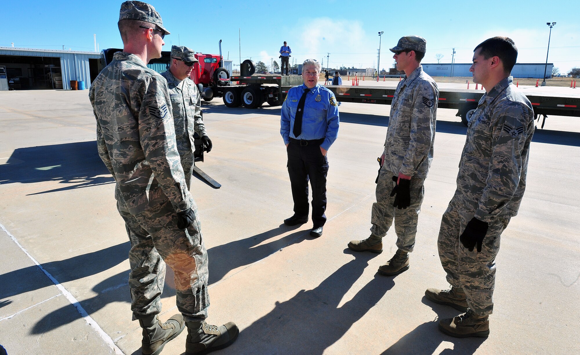 Lt. Scott Fromme, center, of the Wichita Fire Department greets a group of Airmen at the Wichita Fire Department Training Center Feb. 4, 2013, Wichita, Kan. Fromme and the Airmen moved nearly 5 tons of firefighting equipment in preparation for humanitarian shipment to Paraguay. (U.S. Air Force photo/Airman 1st Class Colby L. Hardin)